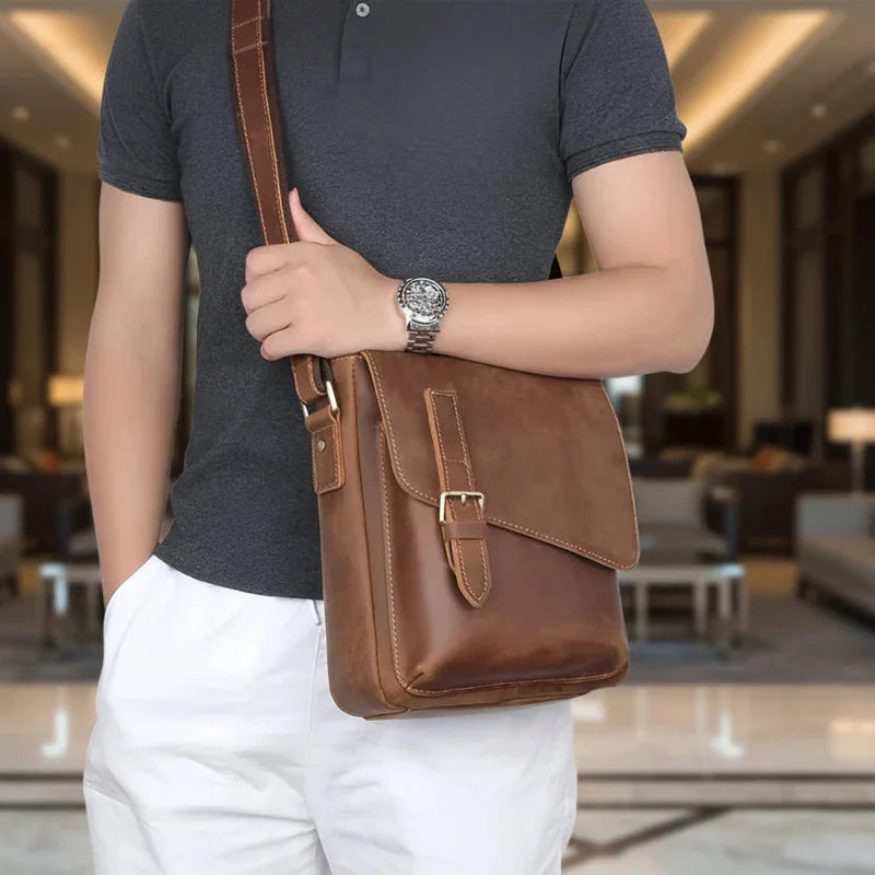 Stylish collection of best leather crossbody bags for vacation displayed with accessories on a wooden table
