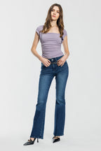 Women's bootcut jeans in dark blue fabric, perfect for pairing with boots