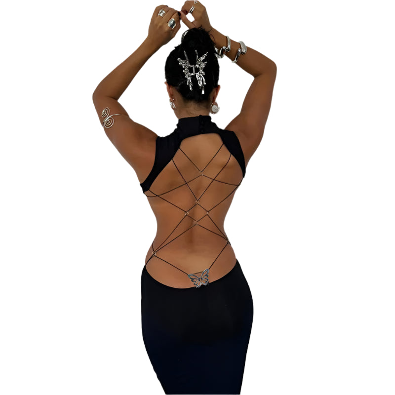 Back view of a woman wearing a black backless cut out club dress with crisscross straps and butterfly detail