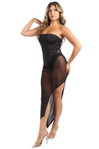 Woman wearing a black strapless dress with sheer panels on a white background
