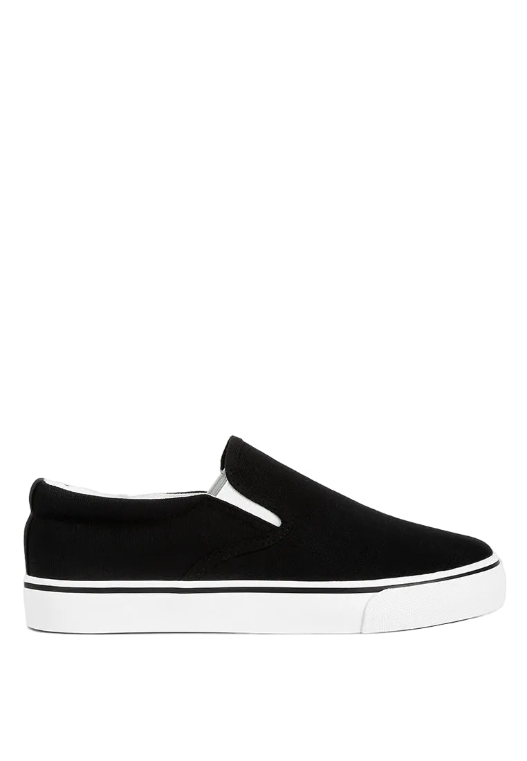 Black slip-on sneaker with white sole on a light gray background