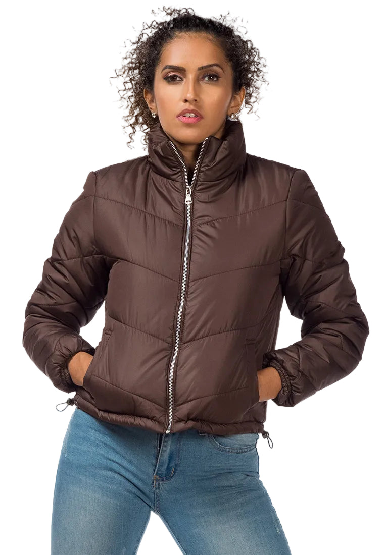 Woman wearing a brown puffer jacket on a white background