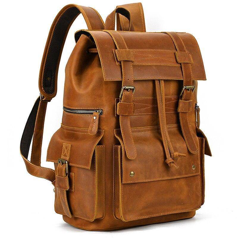 Mens brown leather backpack with multiple pockets and adjustable straps for travel and everyday use
